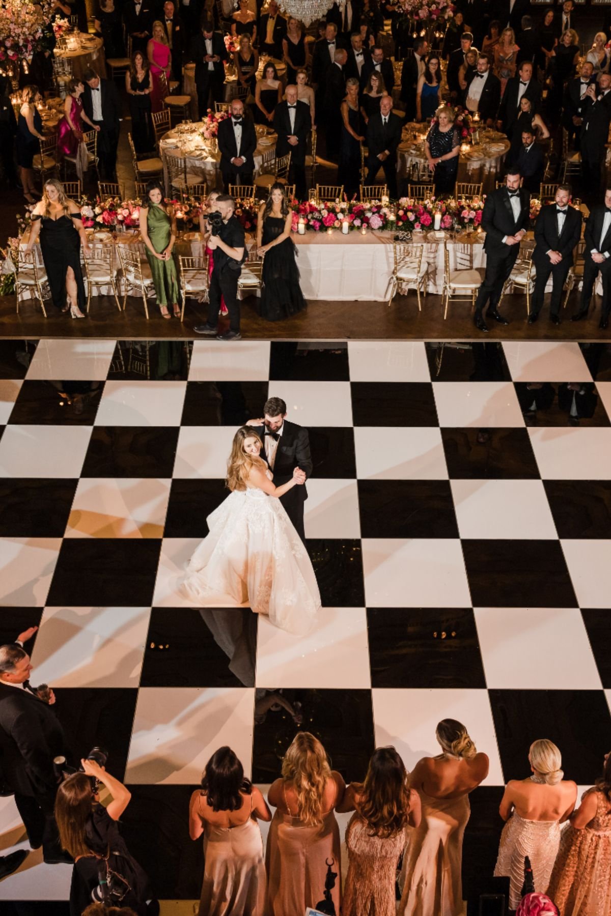 Black and white checkered dance floor rental with bride and groom dancing at a Portland wedding reception