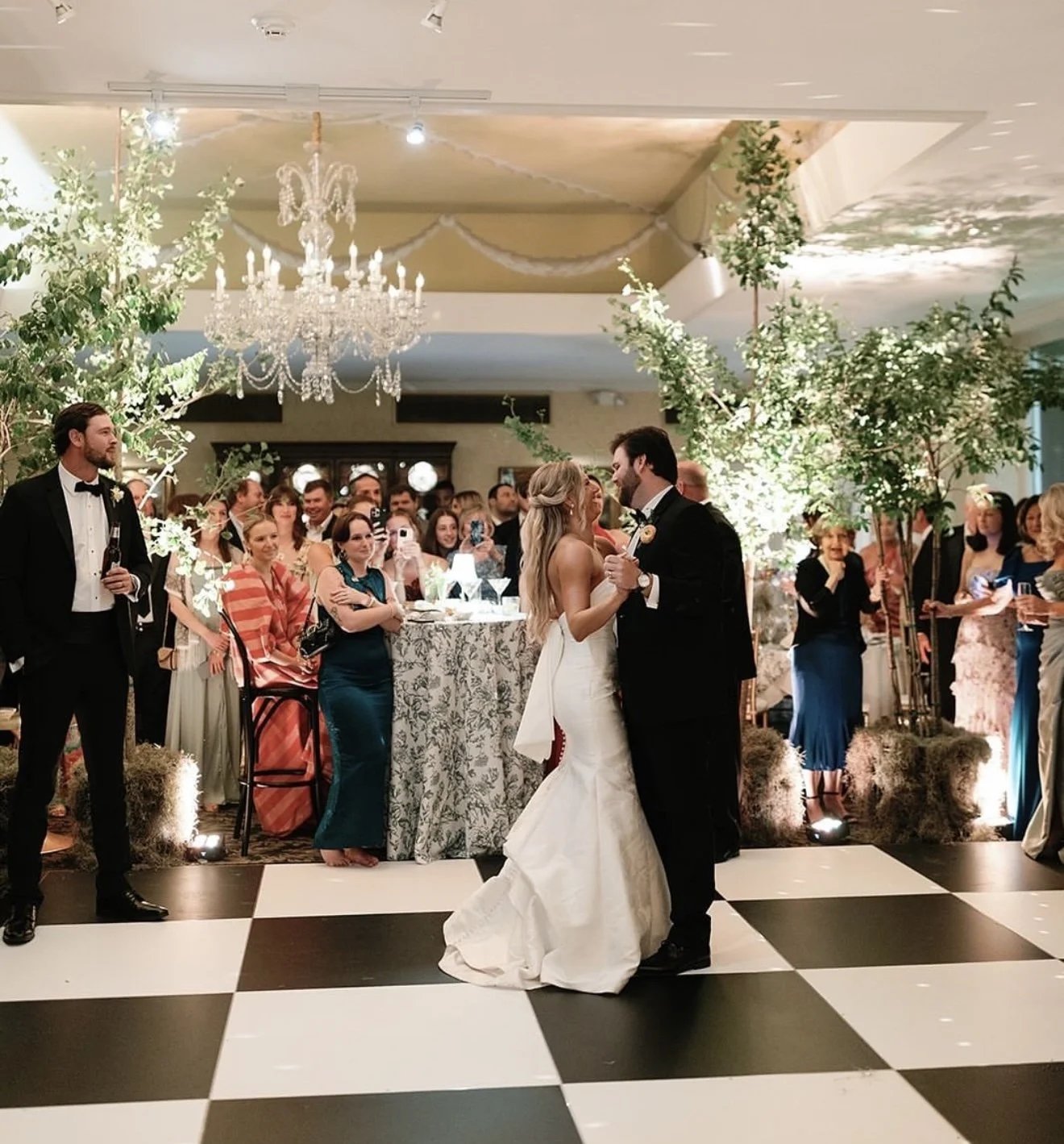 Chandelier lit ballroom with a checkered dance floor set up for a Portland wedding reception