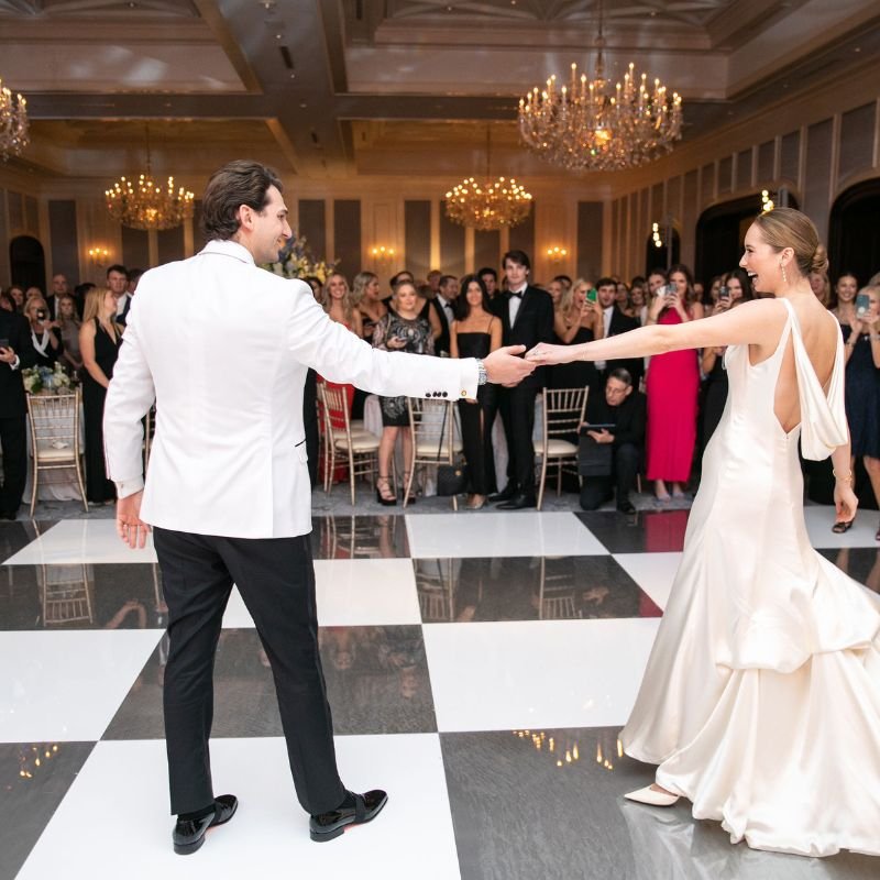 Checkered dance floor set up under a clear tent at an outdoor Portland wedding reception