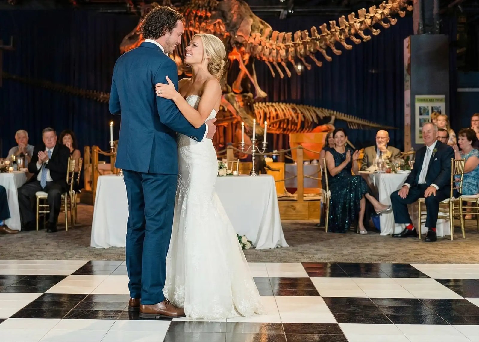Couple dancing on a checkered dance floor at an outdoor evening Portland reception